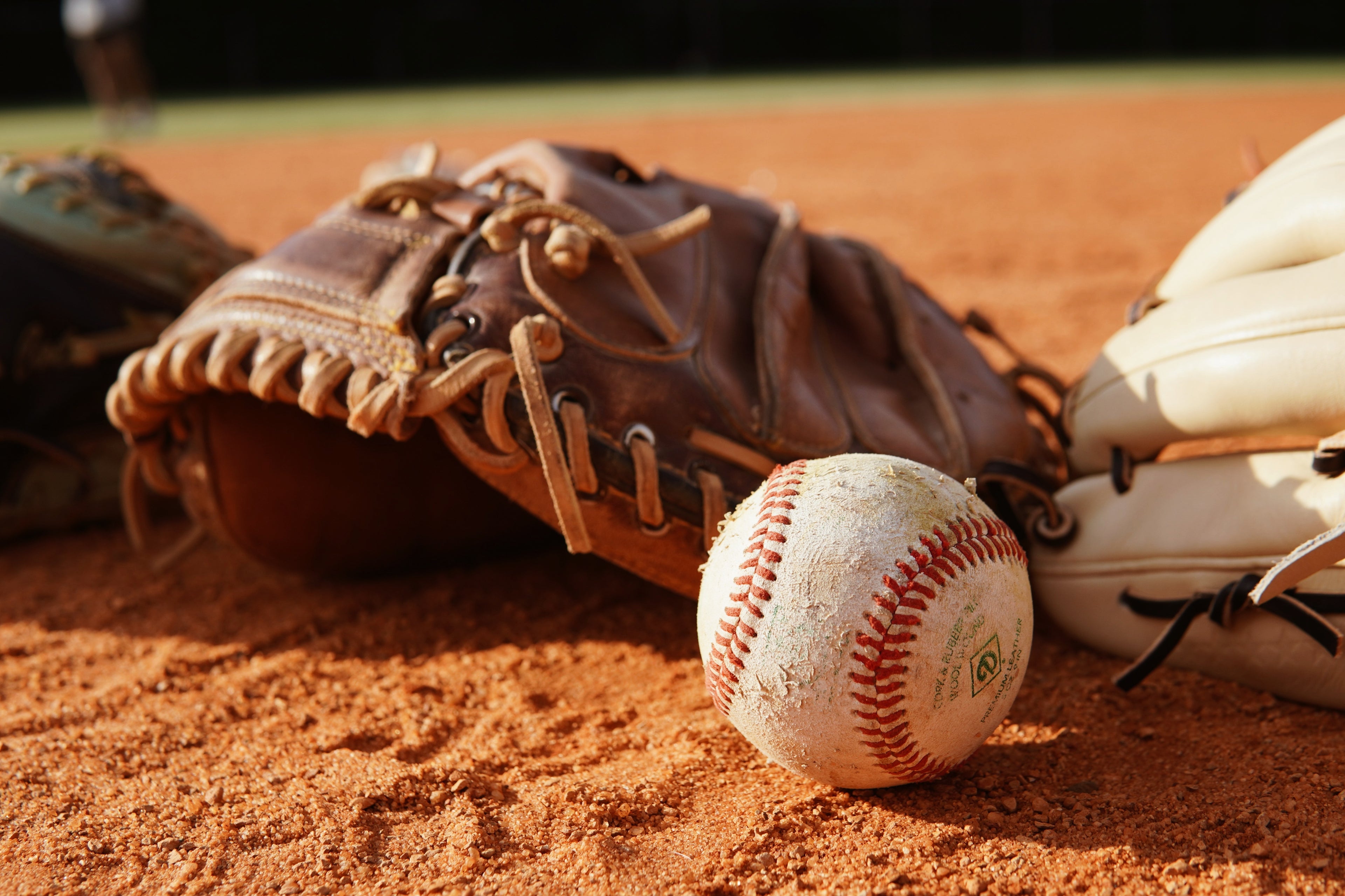 Baseball and gloves on a baseball field